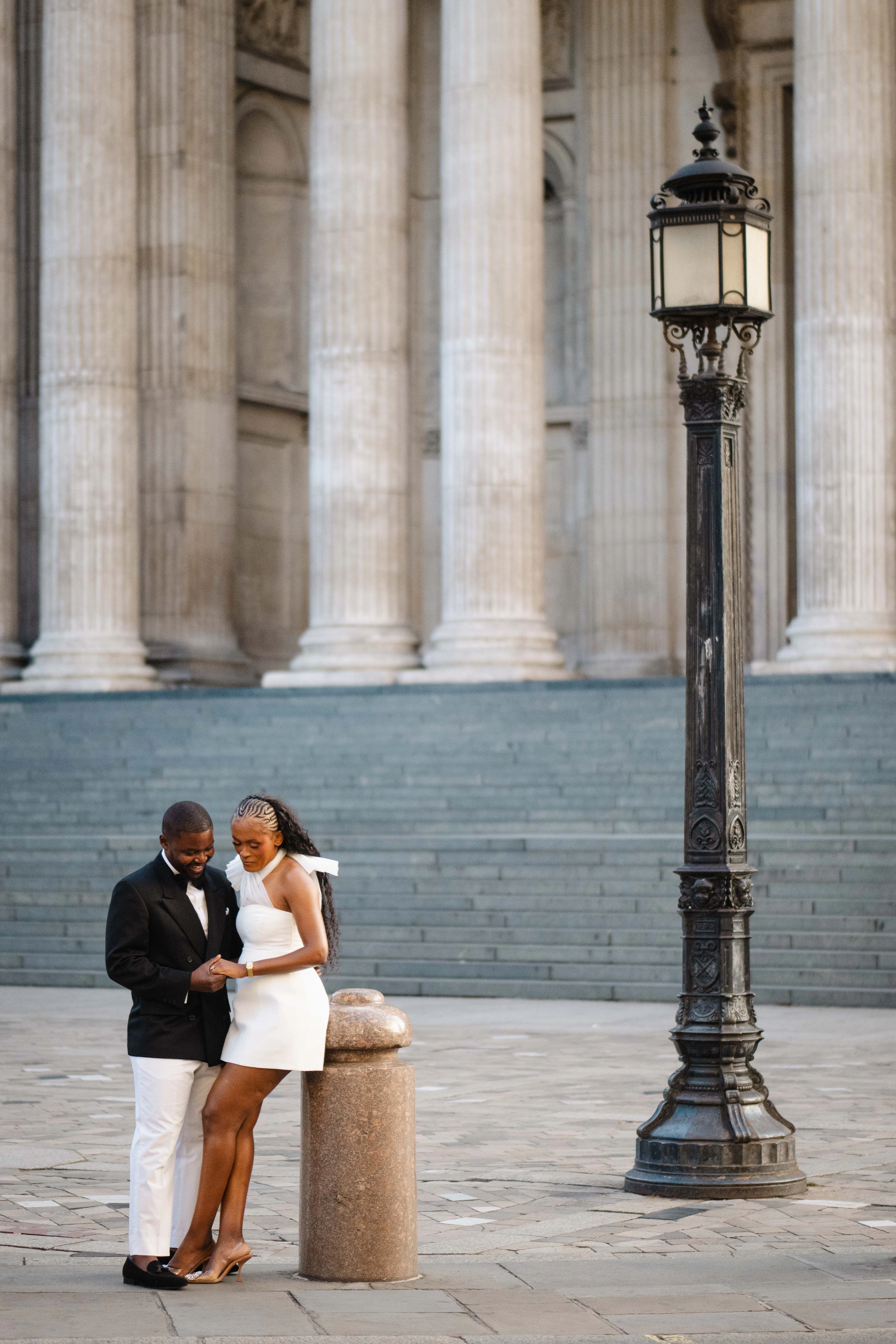Kennedy and Didimalang sharing a quiet moment beside the cathedral lamppost